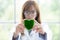 Sciene whit green spirit mind. Green heart in her hand on lab a background. Beautiful smiling female doctor or Scientist holding o