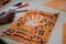 scientific activity for children, drawing and collage of the bones of the hand. On a decorated orange sheet a hand was drawn and