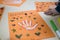 scientific activity for children, drawing and collage of the bones of the hand. On a decorated orange sheet a hand was drawn and