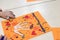 scientific activity for children, drawing and collage of the bones of the hand. On a decorated orange sheet a hand was drawn and
