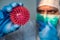 Scientific with protective suit holding Coronavirus red model. Molecule COVID-19