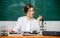 Scientific research. Biology student sit classroom chalkboard background. Chemist biologist with microscope. Smart
