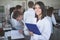 Scientific researcher holding a folder of chemical experiment research. Science students working with chemicals in the lab at the