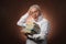 Scientific thinker, philosophy, elderly gray-haired man in a white shirt with a books, with studio light