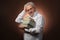 Scientific thinker, philosophy, elderly gray-haired man in a white shirt with a books, with studio light