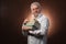 Scientific thinker, philosophy, elderly gray-haired man in a white shirt with a books, with studio light