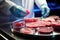 scientist analyzing petri dish with lab-grown meat