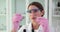 Scientist biologist geneticist looks at two glasses with drop of biological test in medical laboratory and makes