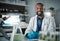 Scientist black man, portrait and lab with smile for research, plants and vision with innovation with senior woman