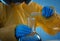 Scientist in chemical protective suit pouring reagent into flask at laboratory, closeup. Virus research