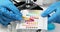 Scientist chemist bringing litmus paper with changed color to scale for determining acidity in lab closeup 4k movie slow