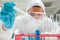 A scientist dropping liquid in a test tube