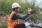 Scientist Ecologist taking a water sample and reading ph value at river. Water pollution and conservation and management of water