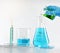 Scientist with equipment and science experiments, Laboratory glassware containing toxic chemical liquid.