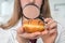 Scientist examines a doughnut with magnifying glass