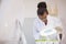 Scientist examining sprouts under heat lamp