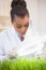 Scientist examining sprouts under heat lamp