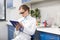 Scientist in eyeglasses writing in clipboard in research laboratory