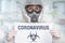 Scientist with FFP3 respirator mask and biohazard logo