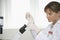 Scientist Filling Test Tube With Pipette In Laboratory