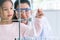 Scientist girl and teacher dropping solution substance liquid with pipette into test tube in lab classroom together. Education and