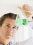 Scientist holding up jar of chemicals