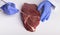 Scientist inspecting meat sample in laboratory, closeup