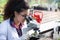 Scientist looking at microscope in greenhouse