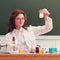 A scientist looks at the reaction of a white turbid chemical liquid. Experiments with chemical reagents at the school desk