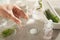 Scientist making cosmetic product at grey table, closeup