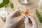 Scientist making cosmetic product at wooden table, above view