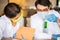 Scientist man holding glass test tube and scientist woman write on notebook. Chemist examines chemical