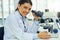 Scientist, portrait and smile of woman with microscope in laboratory for medical research. Face, science and female