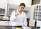 Scientist pouring a liquid in an Erlenmeyer flask