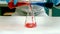 Scientist pouring liquid into a erlenmeyer flask