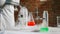 Scientist pouring liquid nitrogen in steel thermos bottle at laboratory