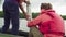 A scientist pouring sample of water from lake into plastic bottle