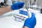 Scientist prepare blood sample for research on microscope. Placing blood sample on microscope slide