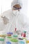 Scientist in Protective Clothing in Lab