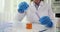 Scientist researcher conducting scientific research in scientific laboratory mixes liquids in glass