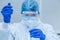 Scientist or researcher hand in blue gloves holding flu, measles, coronavirus, covid-19 vaccine disease