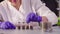 The scientist`s hands hands close bottles with samples