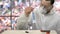 Scientist shaking test tube with reagents to observe a reaction.