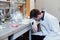 Scientist sleeps in the workplace in a medical laboratory