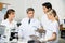 Scientist With Students Taking Notes In Laboratory