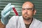 Scientist with a test tube and red liquid