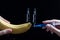 Scientist testing GMO plant in laboratory on a banana-biotechnology and GMO concept.GMO genetically modified food. Hands holding a