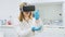 Scientist uses chemical equipment wearing Virtual Reality headset.