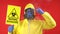 Scientist. Virologist. Factory worker in a Coverall suit points to a biohazard sign. Biological hazard emergency