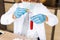 Scientist wear white coat and blue gloves holding dropper and drop red water to tube science.